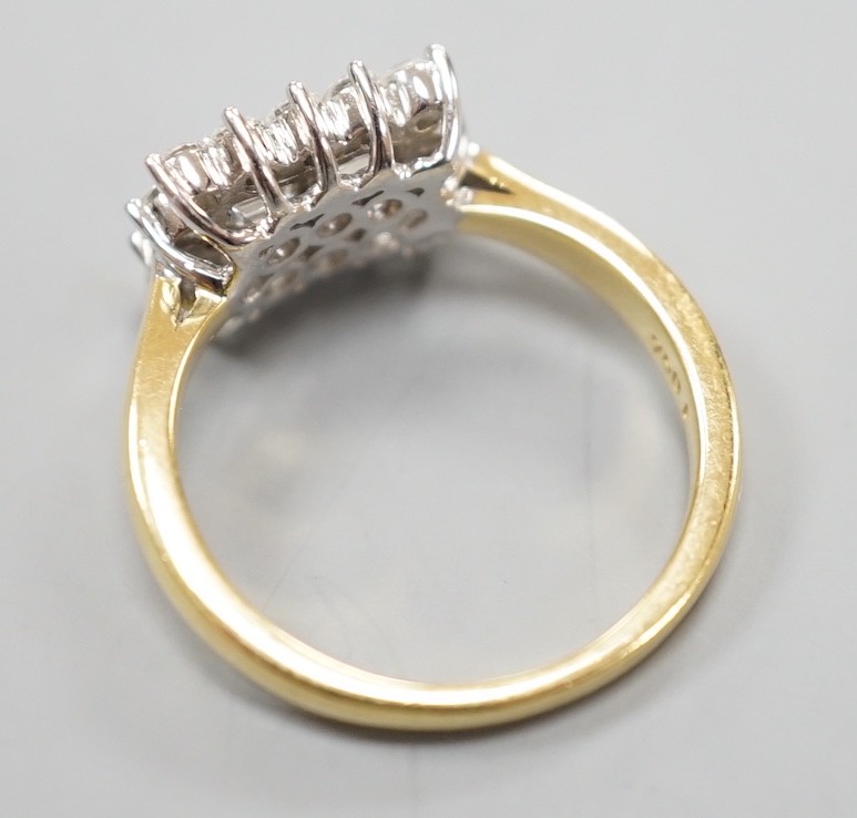A 750 yellow metal, baguette and round cut diamond set rectangular cluster ring, size M, gross weight 4.8 grams.